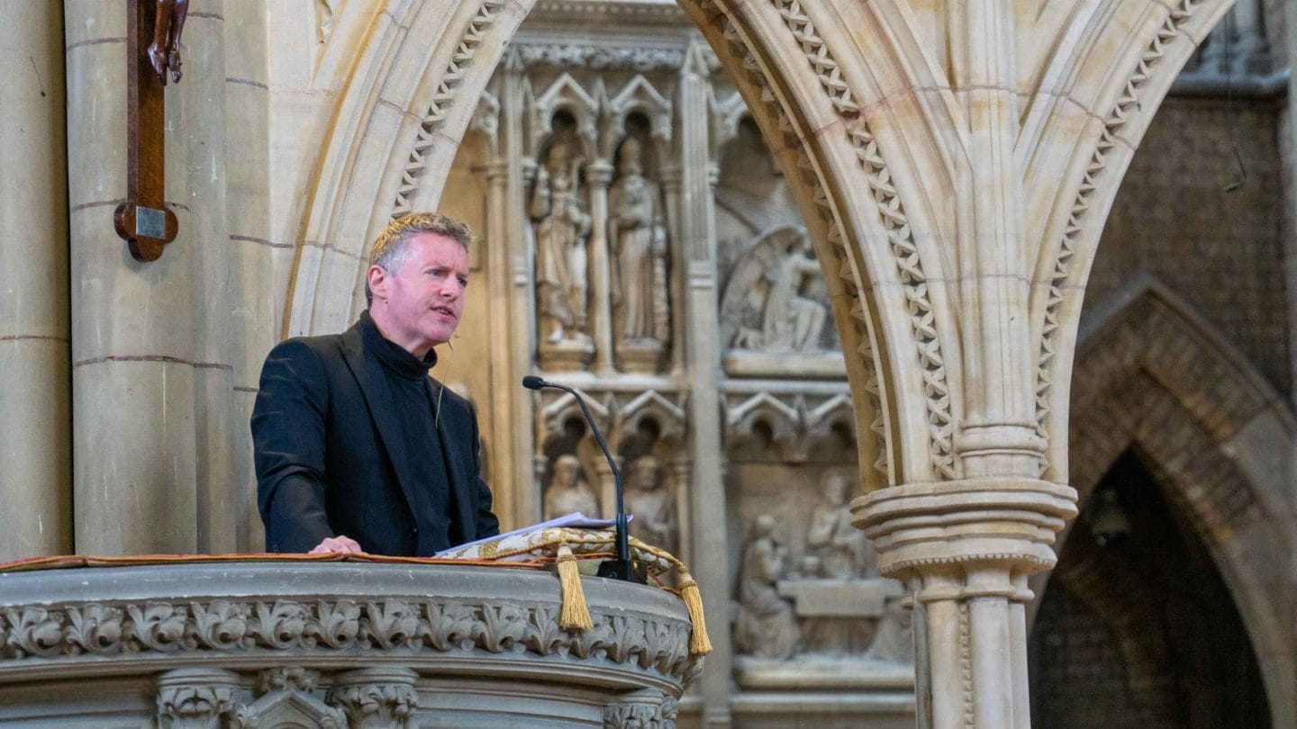 Man standing in church pulpit.