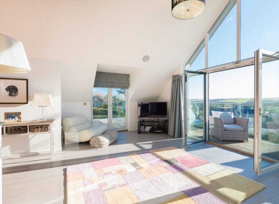 A brightly lit living room with tall white ceilings
